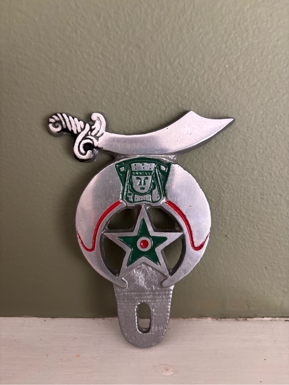 Decorative Silver Shriner Wall Accent with Green and Red Detailing